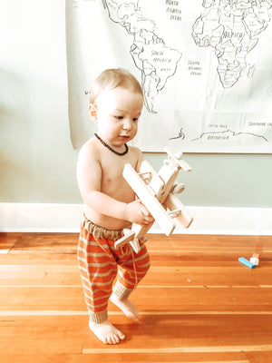 Child playing with a Wooden Toy Airplane